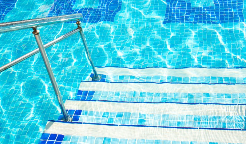 Pool entrance with steps and railings