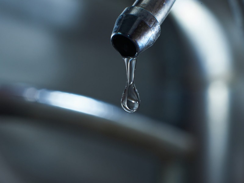 Reverse osmosis filter tap closeup with dripping water-drop.